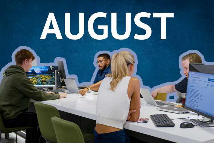 A promotional graphic with the word “AUGUST” in large white capital letters against a textured dark blue background. In the foreground, four people are seated around a white table in a modern office workspace, using desktop computers and laptops. Green chairs surround the table, and computer monitors, keyboards, and work materials are visible, creating a collaborative office setting.